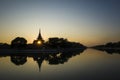 Mandalay Palace wall and moat picturesque silhouette with twilight sky in sunset with sun shining through tower window Royalty Free Stock Photo