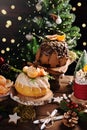 Mandarin flavored ring cake decorated with fresh fruits and chocolate glaze cake on rustic style Christmas table