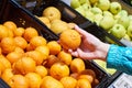 Mandarin fruit in hand in store