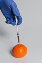 Mandarin injected with pesticides needle syringe