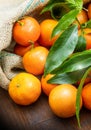 Mandarin oranges fruit with leaves on wooden table