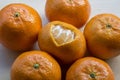 Mandarin with peel in heart form with several mandarins around