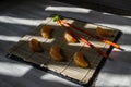 Mandarin or tangerine with chopsticks as sushi