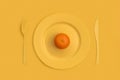 Mandarin on top on a yellow plate, knife and fork. On a yellow background. View from above Royalty Free Stock Photo