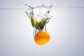 Mandarin in water with a splash and air bubbles Royalty Free Stock Photo