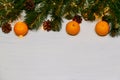 Mandarine fruits and christmas tree branches over rustic wooden background. Christmas concept