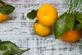 Mandarine fruits and christmas tree branches over rustic wooden background