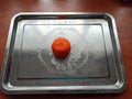 Mandarine on iron tray on wooden table