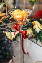 Mandarines in a glass vase with red ribbon
