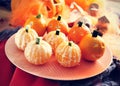 Mandarines ornamented as Halloween pumpkins