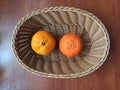 Mandarines in wooden basket on wooden table Royalty Free Stock Photo