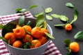 Mandarins or clementines with leaves on a black background. Tangerines in a plate. Royalty Free Stock Photo