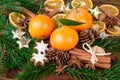 Mandarins fruits with fir branch and christmas spices on wooden table Royalty Free Stock Photo