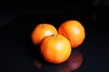 Mandarins. Mandarin citrus orange fruit mandarins on black reflective studio background. black shiny mirror mirrored back