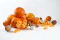 Mandarins on a white background with lobule, peel, citron and litchi. Side view, close. Citrus reticulata. Litchi chinensis