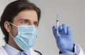 Mandatory Vaccination Concept. Closeup Of Male Doctor Holding Syringe With Vaccine