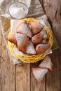 Mandazi, also known as theÃÂ daboÃÂ orÃÂ South Sudanese Coconut Doughnut close-up in a basket. Vertical top view