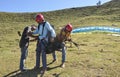 Mandi, Himachal Pradesh, India - 10 16 2021: Paragliders help to a tourist for adjusting parachute adjustment