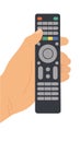 Hand holding remote control pressing television button Royalty Free Stock Photo