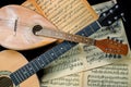 Mandolin and guitar with blurred sheet music books Royalty Free Stock Photo