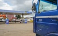 Mandraka, Madagascar - April 24, 2019: Typical gas station - Jovenna brand - at Madagascar on overcast day. Blue truck with broken Royalty Free Stock Photo