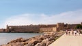 MANDRAKI HARBOUR, RHODES, GREECE - MARCH 18, 2020: View the embankment and the medieval fortress, Rhodes, Greece
