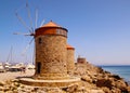 MANDRAKI HARBOUR, RHODES, GREECE - MARCH 18, 2020: View of the embankment and the medieval fortress and windmills, Rhodes, Greece