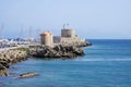 Mandraki Marina and port with Rhodes Windmills and Fort of Saint Nicholas, Greece Royalty Free Stock Photo