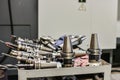 Mandrels and accessories for the CNC milling machine are located on the machine near the industrial equipment. Drills, cutters,