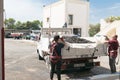 Manduria, Italy, september 07, 2019 - two men open the truck and throw the grapes in the grape destemmer in a winery. Primitivo Royalty Free Stock Photo