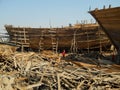 Workers building a wooden dhow ship at the ship building yard in the coastal town of Mandvi