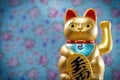 Maneki neko, Goldon lucky cat with a colored background, postcard