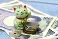 Maneki-neko, the lucky cat and Japanese money. Royalty Free Stock Photo