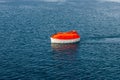 Maneuvering orange lifeboat in water in Arctic waters, Svalbard. Abandon ship drill. Lifeboat training. Man over board drill Royalty Free Stock Photo