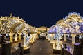 Manezhnaya square during New Year and Christmas holidays with glowing multi-colored arch, Moscow