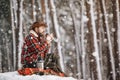 Manful Hiker Drinking Coffee During a Halt in Winter Forest