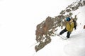 Manful snowboarder jumping down the hill in the mountain resort Royalty Free Stock Photo