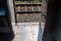 Metal footboard beside the door of a train run by Indian railways Royalty Free Stock Photo