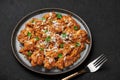 Mangalorean Chicken Sukka on black plate on dark slate table top. Indian cuisine coconut curry dish. Asian food and meal Royalty Free Stock Photo