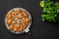 Mangalorean Chicken Sukka on black plate on dark slate table top. Indian cuisine coconut curry dish. Asian food and meal Royalty Free Stock Photo