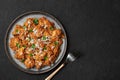 Mangalorean Chicken Sukka on black plate on dark slate table top. Indian cuisine coconut curry dish. Asian food and meal Royalty Free Stock Photo