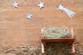 Manger and star of Bethlehem abstracy christmas background nativity scene on wooden board