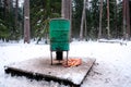 Manger for winter feeding of wild animals in forest. Forest animal feeder in winter. Defocused