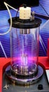 Mangetron sputtering with purple glowing plasma in vacuum glass tube