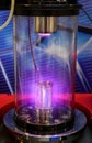 Mangetron sputtering with purple glowing plasma in vacuum glass tube