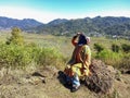 Manggarai, East nusa tenggara, Indonesia - 2022: A Muslim woman is posing on a hill with a beautiful and stunning natural view