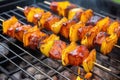 mango bbq plantains on a skewer over a smoky barbecue grill