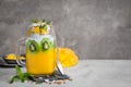 Mango, coconut and chia seeds pudding in glass jar