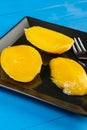 Mango Compote Served On The Plate With Fork