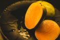 Mango fruit on the black plate,vintage color tone. Royalty Free Stock Photo